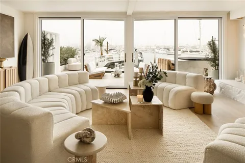 a living room with furniture a fireplace and a large window