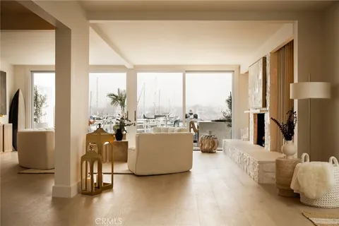 a very nice looking room with a large window and furniture