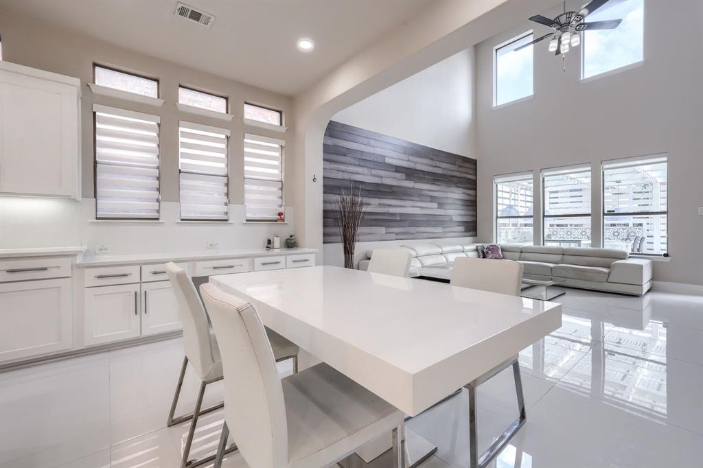 2246 Longview Road Irving, TX 75063 - Photo 12 of 40 Open-concept living space featuring high ceilings, modern wood-finish accent wall, and expansive windows