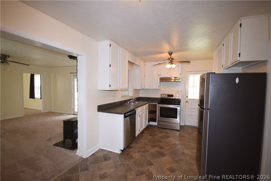 108 South 6th Street Spring Lake, NC 28390 - Photo 9 of 20 a kitchen with granite countertop a refrigerator and a stove