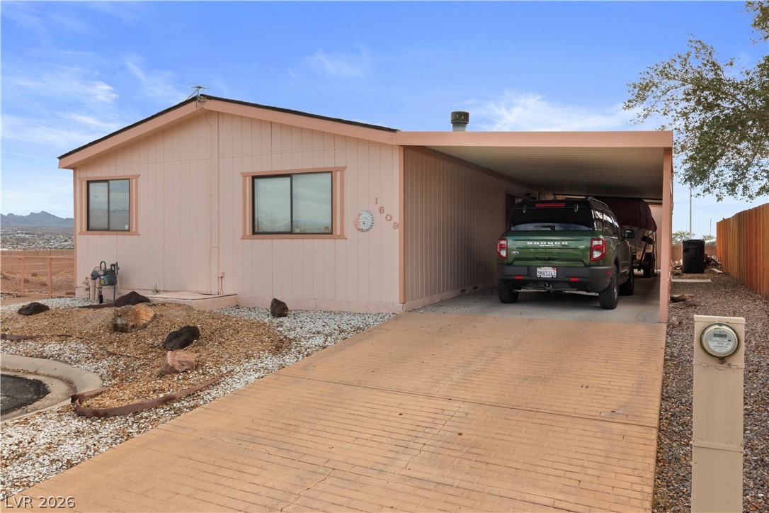 1609 Cajon Court Laughlin, NV 89029 - Photo 30 of 69 View of right side of home with driveway and an attached covered carport
