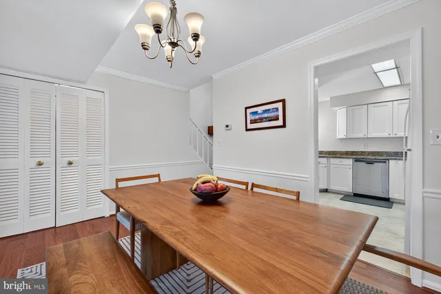 a bedroom with a table chairs and wooden floor