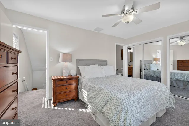 a spacious bedroom with a bed and a chandelier