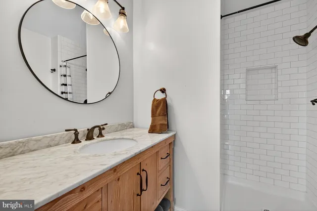 a bathroom with a sink vanity and a mirror