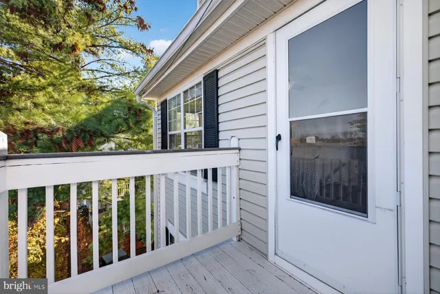 a view of a porch with wooden floor and fence