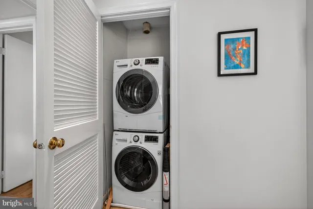 a view of a hallway with washer and dryer