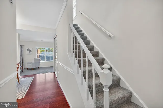 a view of entryway and hall with wooden floor