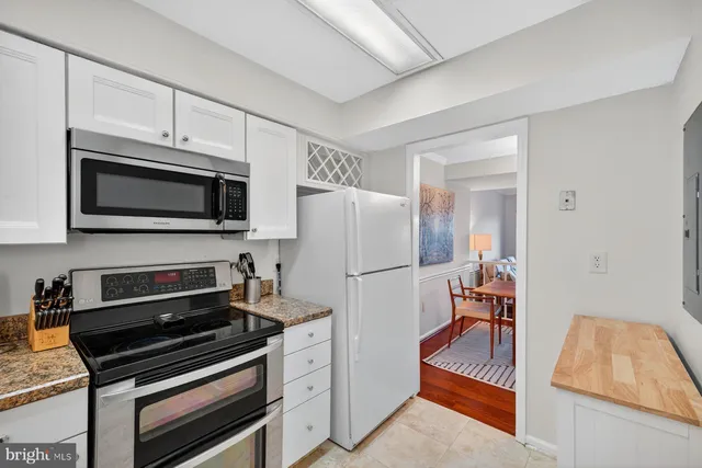 a kitchen with wooden cabinets and stainless steel appliances