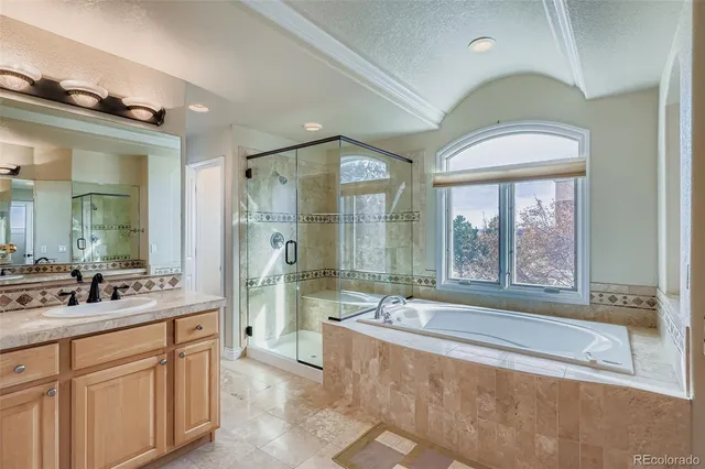 a spacious bathroom with a sink mirror and a bathtub