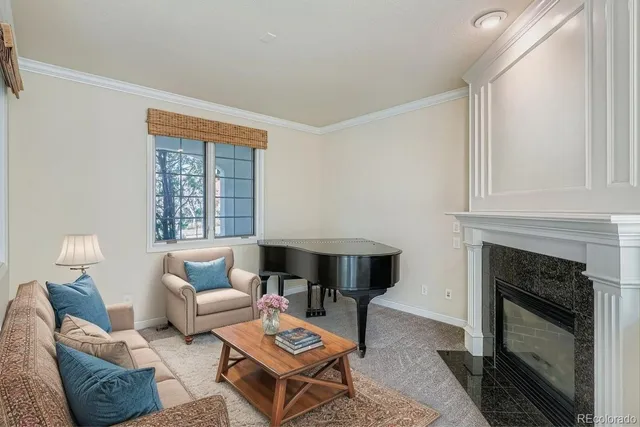 a living room with furniture a fireplace and a window