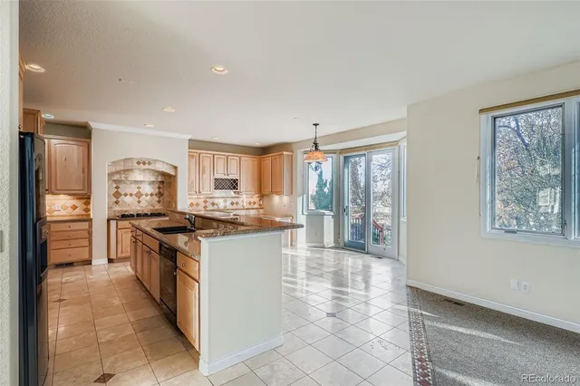a kitchen with stainless steel appliances granite countertop a stove and a refrigerator