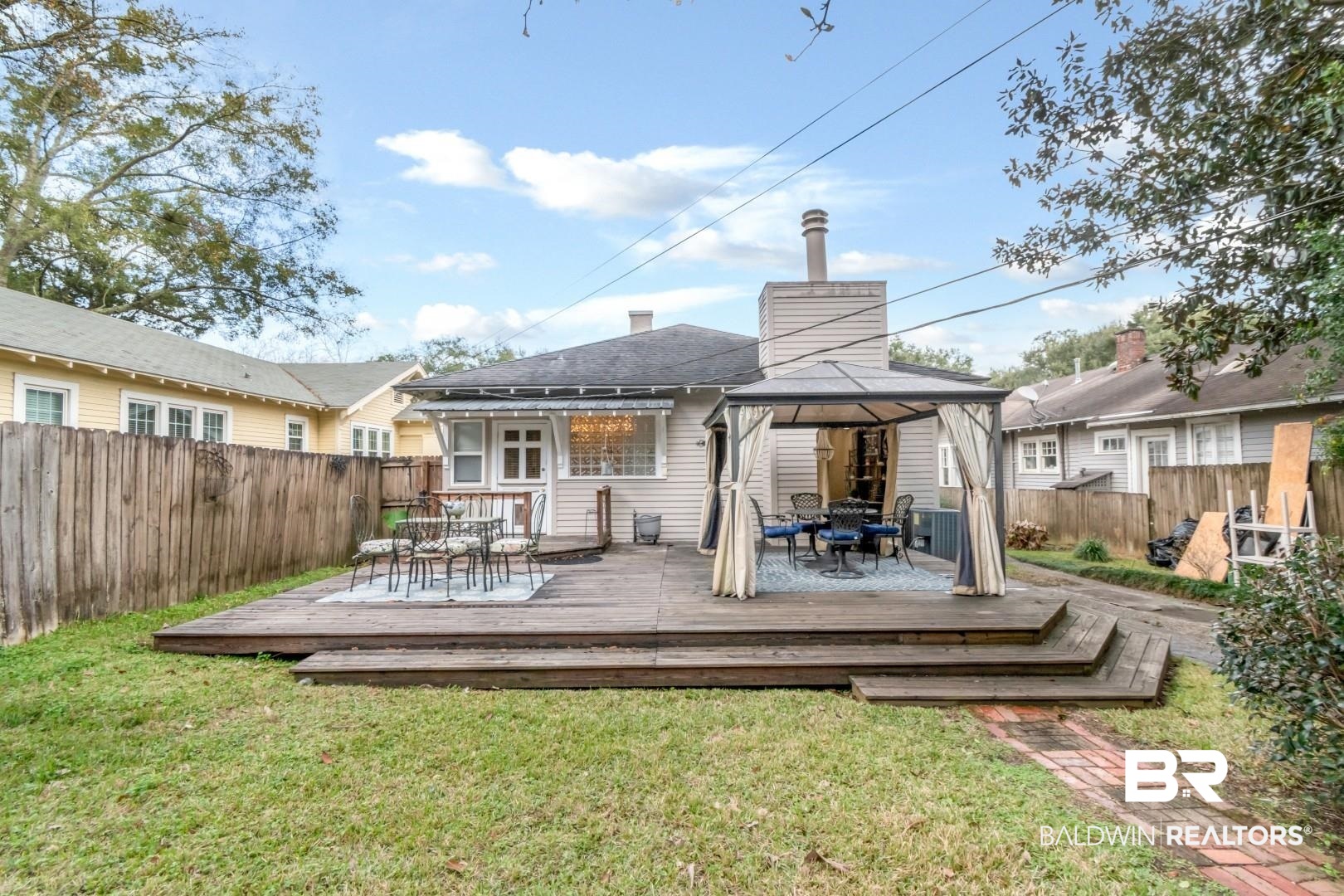 135 Silverwood Street Mobile, AL 36607 - Photo 28 of 32 Rear view of house with outdoor dining area, a gazebo, and a wooden deck