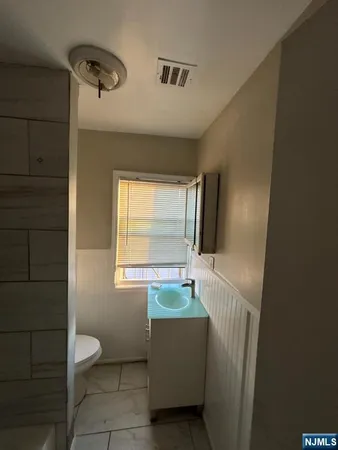 a bathroom with a toilet a sink and bathtub