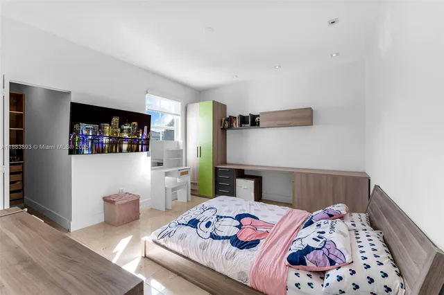 a bedroom with furniture and a wooden floor