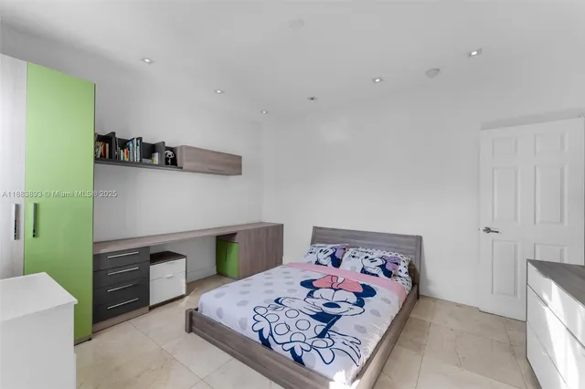 a bedroom with a bed and a television