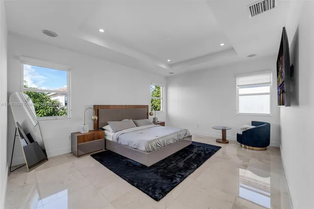 a bedroom with a bed a window and dresser