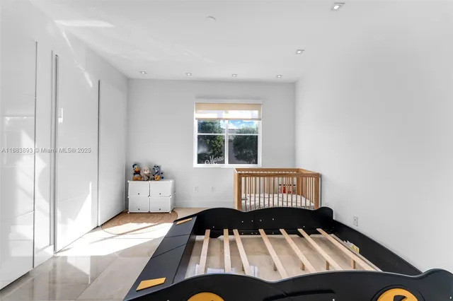 a view of a bedroom with wooden floor and a window