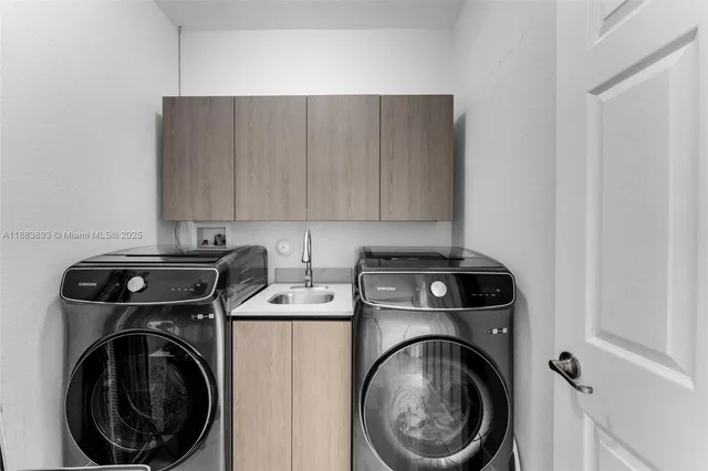 a view of a storage and utility room with washer and dryer