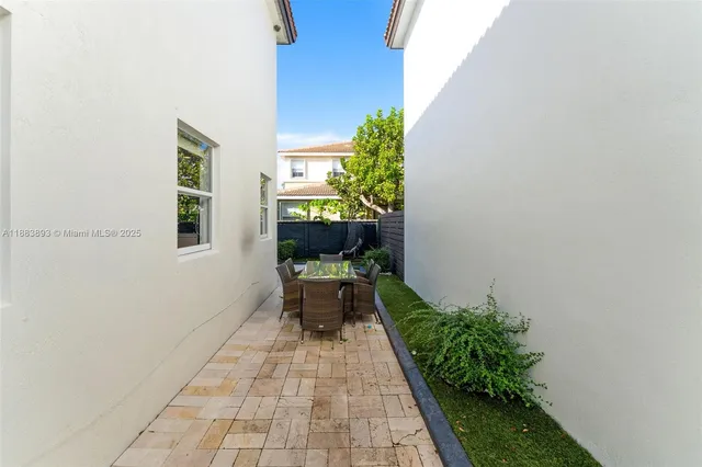 a backyard with potted plants and wall