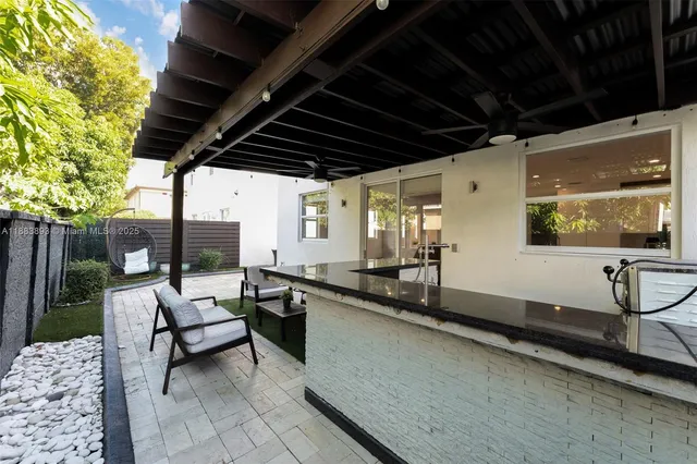 an aerial view of a city with lots of residential buildings and mountain view in back