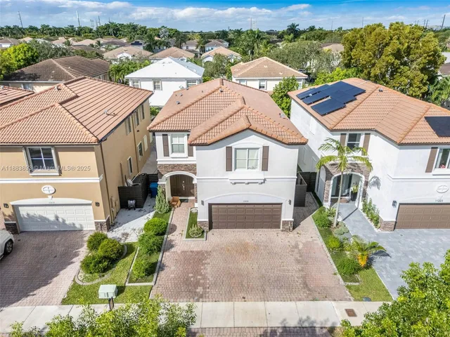 an aerial view of residential houses with outdoor space