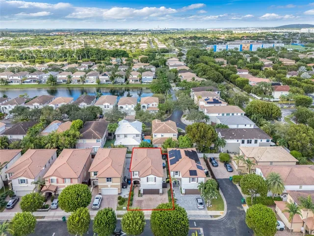 an aerial view of residential houses with outdoor space