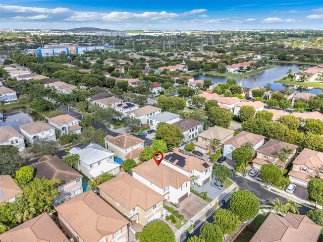 an aerial view of a house with yard swimming pool and outdoor seating