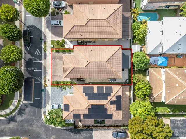 an aerial view of a house with swimming pool and patio