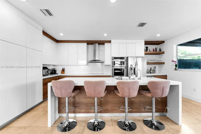 a kitchen with a dining table chairs and view living room