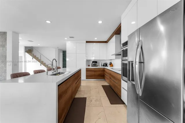 a large kitchen with stainless steel appliances lots of counter top space