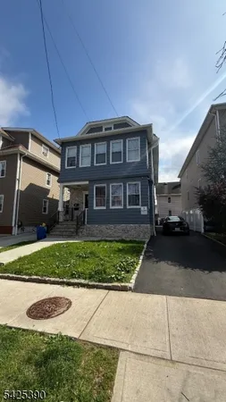 a front view of a house with a yard and outdoor space