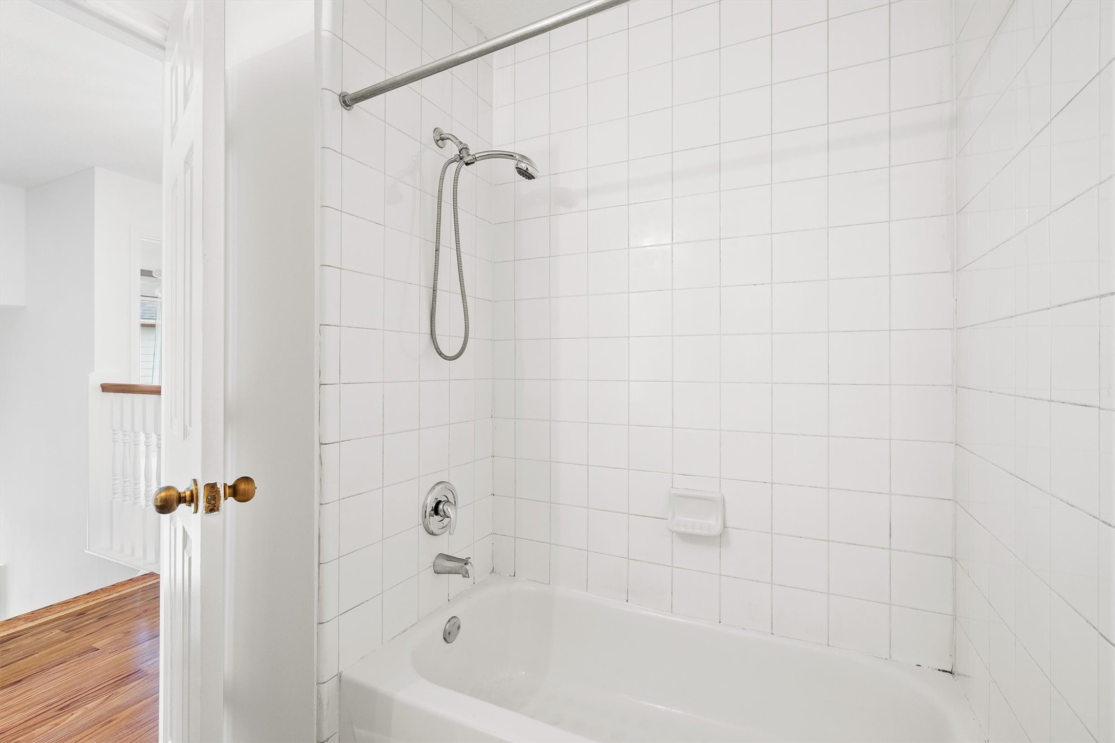 5426 Bourgeois Road Houston, TX 77066 - Photo 32 of 43 Bright and clean guest bathroom featuring a classic white tiled shower and bathtub, offering a fresh and inviting space.