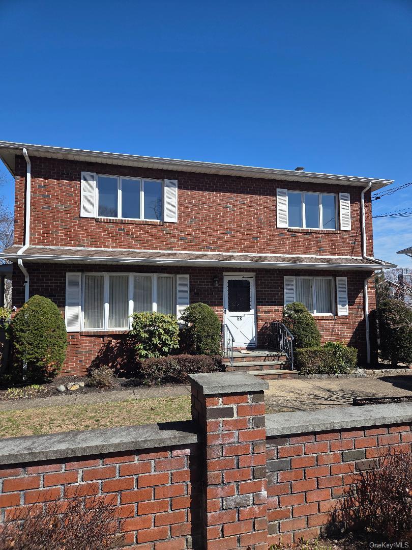 68 Kirkwood Road Port Washington, NY 11050 - Photo 1 of 9 a front view of a house with porch