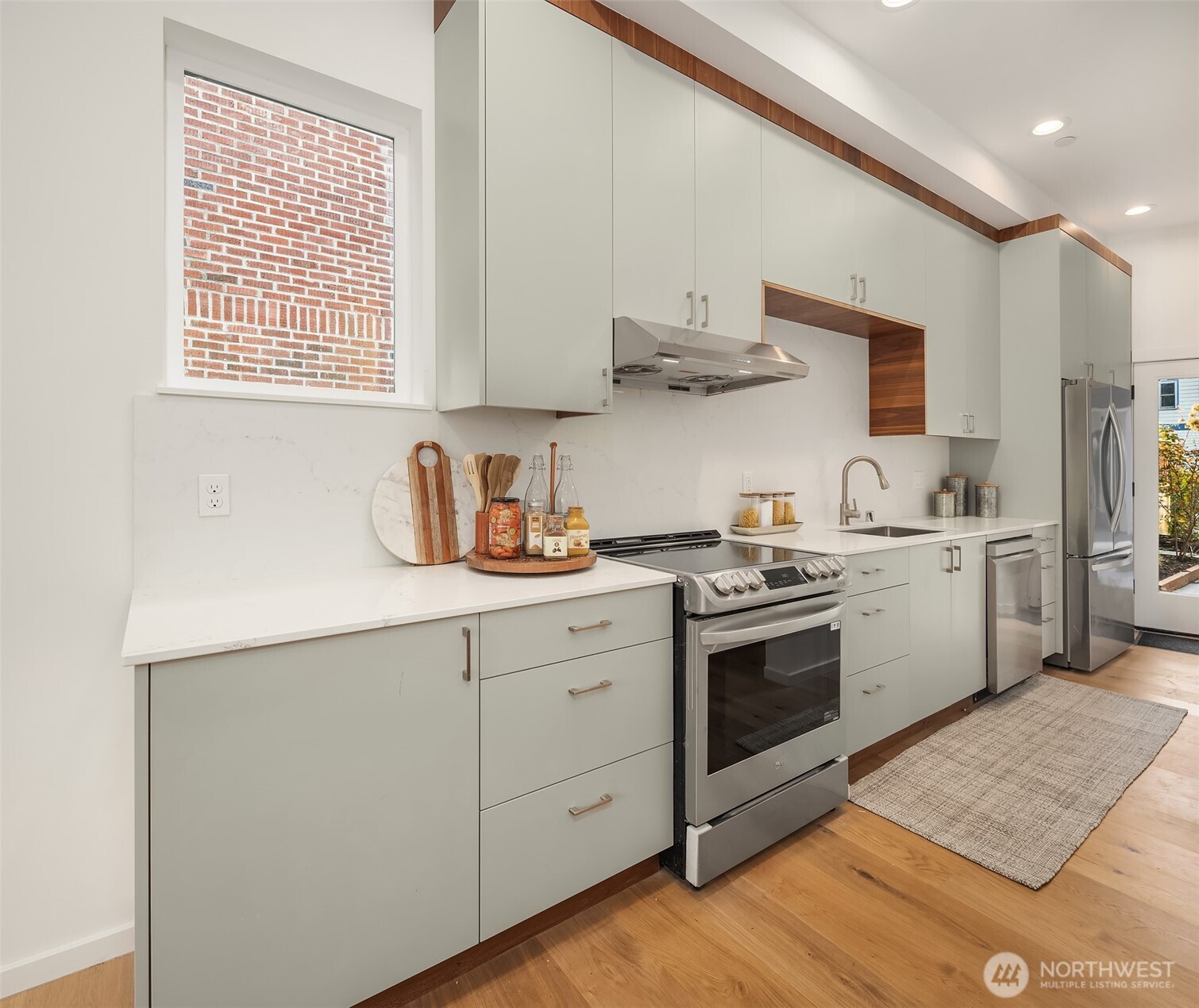 629 13th Avenue East Seattle, WA 98102 - Photo 7 of 36 a kitchen with stainless steel appliances granite countertop a sink a stove and a refrigerator