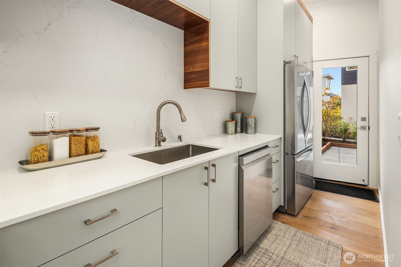 629 13th Avenue East Seattle, WA 98102 - Photo 8 of 36 a kitchen with stainless steel appliances a sink and a refrigerator