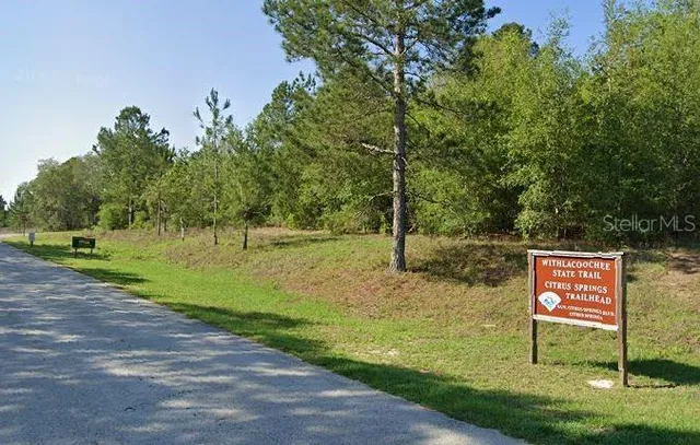 a sign board with yard in the back