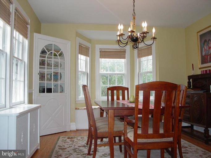 7007 Copeleigh Road Baltimore, MD 21212 - Photo 10 of 30 a view of a dining room with furniture wooden floor and chandelier