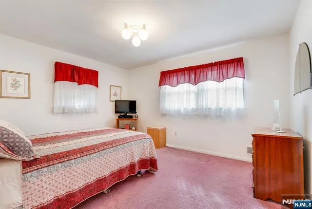 a view of a house with a big yard and large trees