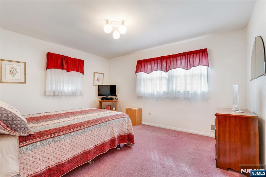 378 Lookout Avenue Hackensack, NJ 07601 - Photo 12 of 32 a bedroom with a bed and a lamp on dresser