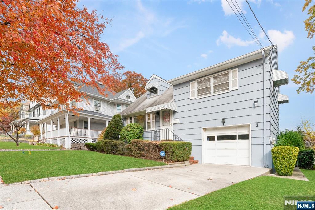 378 Lookout Avenue Hackensack, NJ 07601 - Photo 2 of 32 a front view of a house with a garden and plants