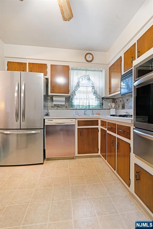 378 Lookout Avenue Hackensack, NJ 07601 - Photo 10 of 32 a kitchen with stainless steel appliances granite countertop a stove a sink and a refrigerator