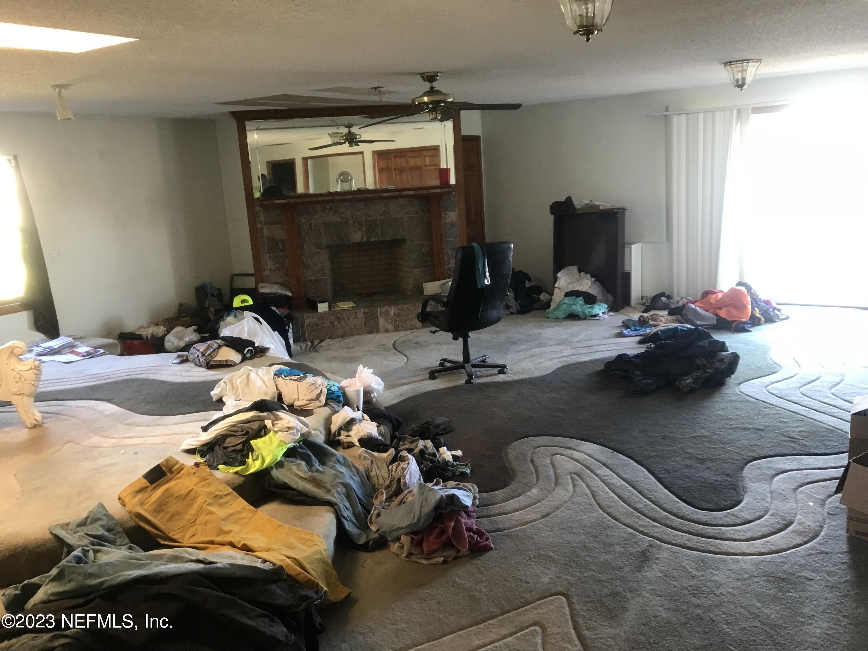 8063 Appian Way Jacksonville, FL 32208 - Photo 15 of 27 a bedroom with bed and a mirror