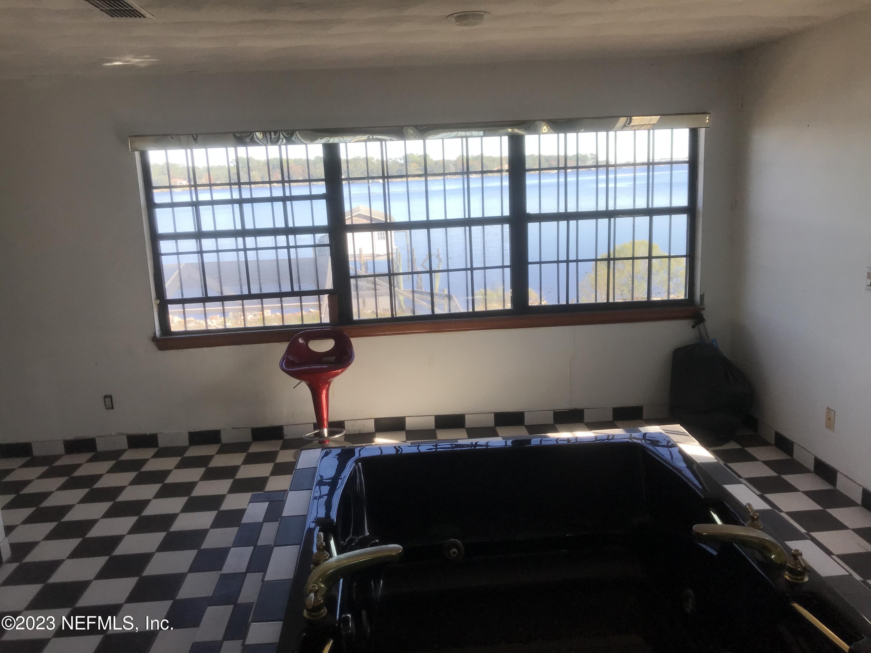 8063 Appian Way Jacksonville, FL 32208 - Photo 21 of 27 a bedroom with a bed and a window