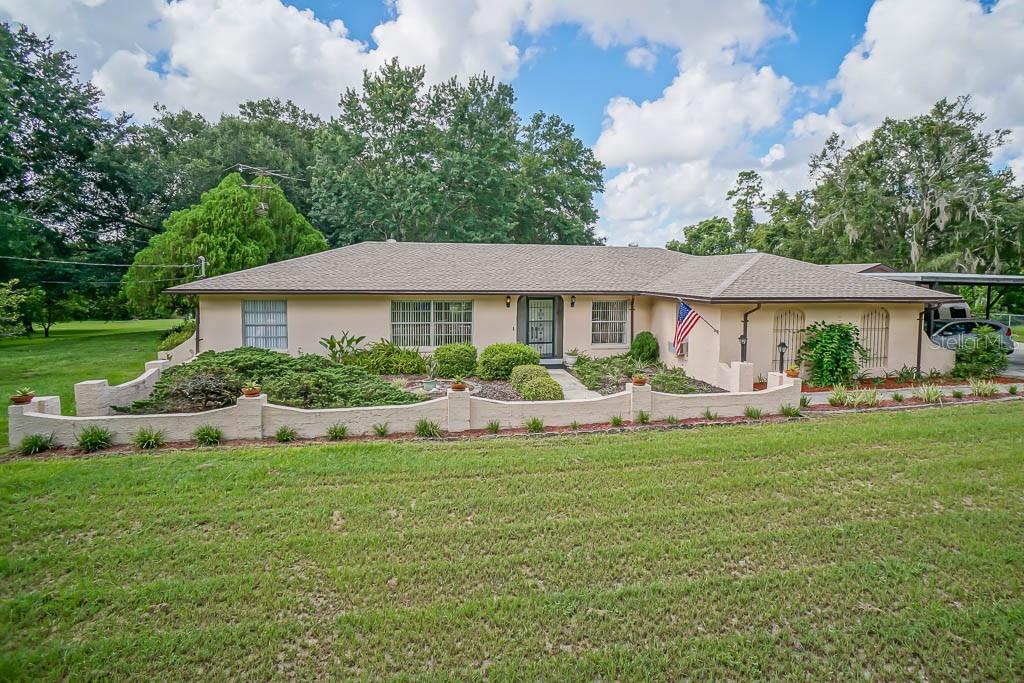4977 Lake Sparling Road Orlando, FL 32808 - Photo 1 of 1 a view of a house with a yard and sitting area
