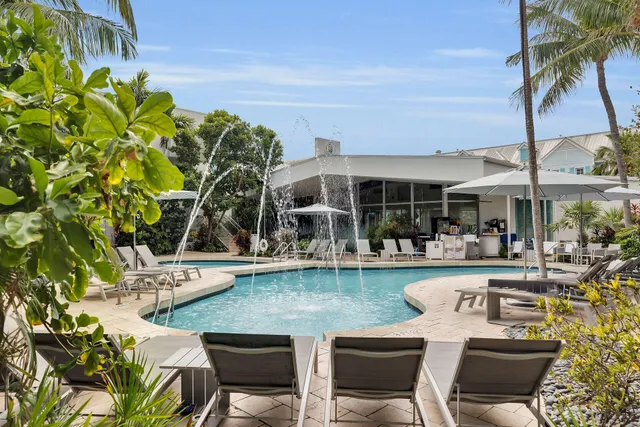 a view of a chair and tables in the patio and a swimming pool