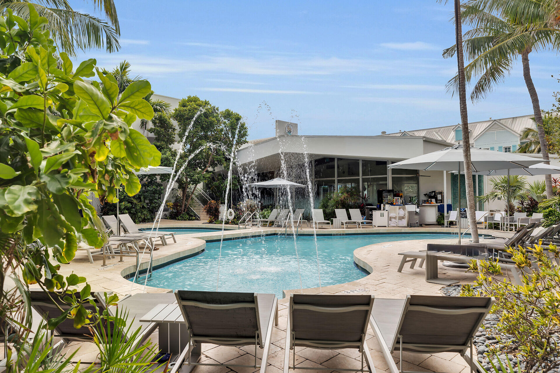 a view of a chair and tables in the patio and a swimming pool