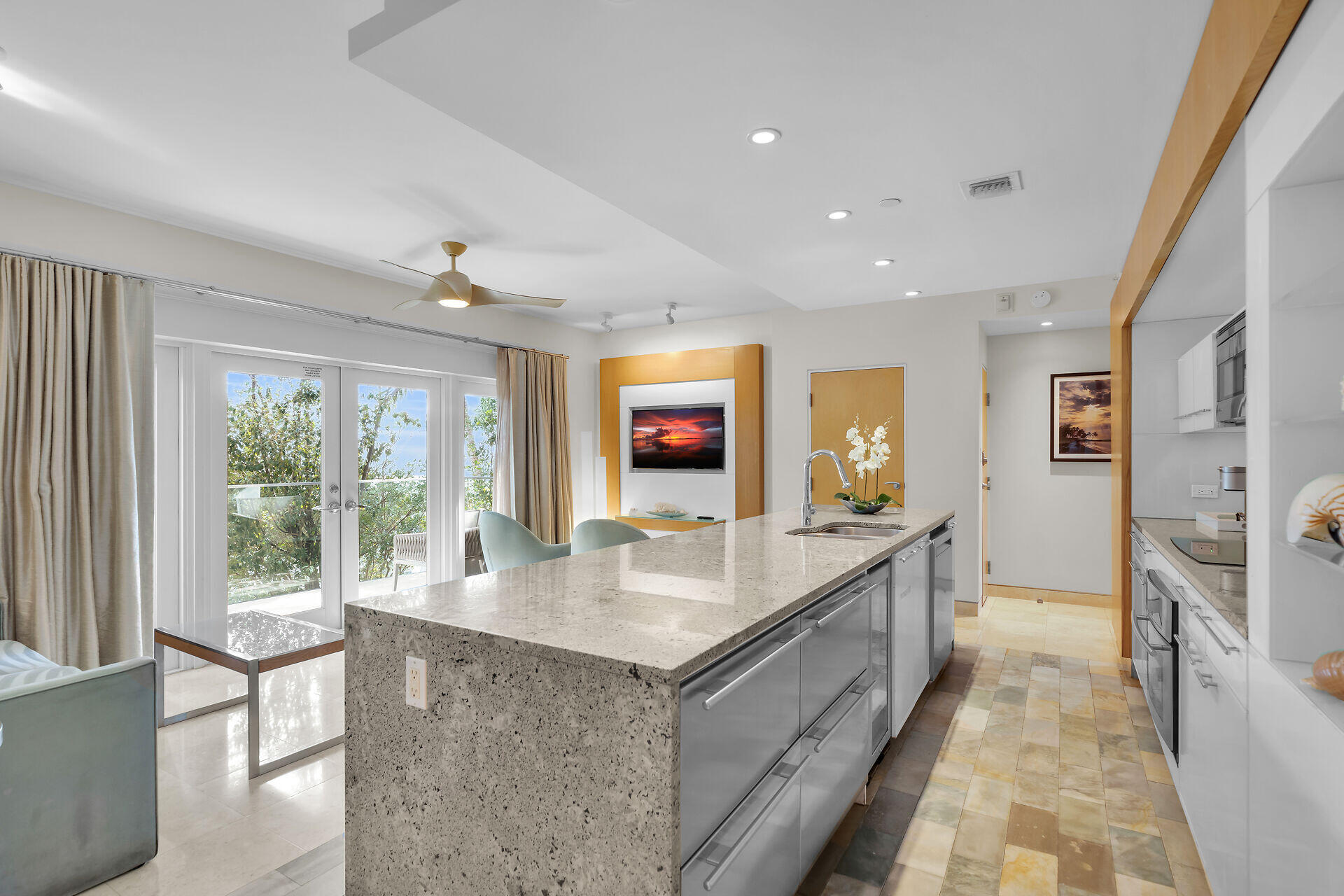 1401 Simonton Street, Unit 16 Key West, FL 33040 - Photo 7 of 29 a large kitchen with kitchen island granite countertop a large window and stainless steel appliances