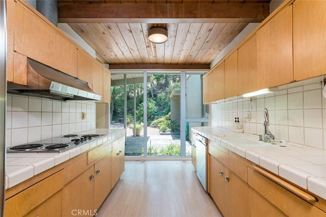 a kitchen with a stove and a refrigerator