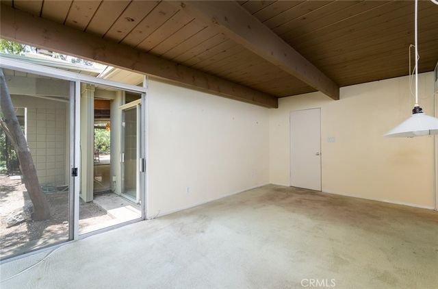 a room with a window and a wooden floor