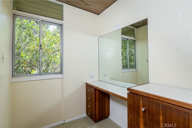 a spacious bathroom with a granite countertop sink a mirror and a shower